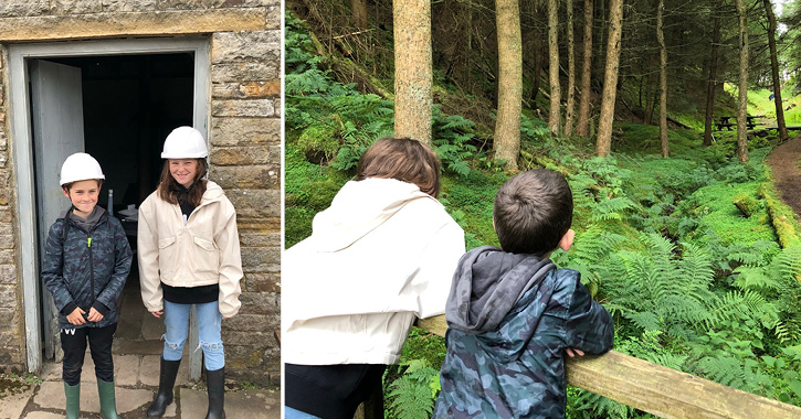 girl and boy with hat hard and wellies on and looking into woodland at Killhope Lead Mining Museum